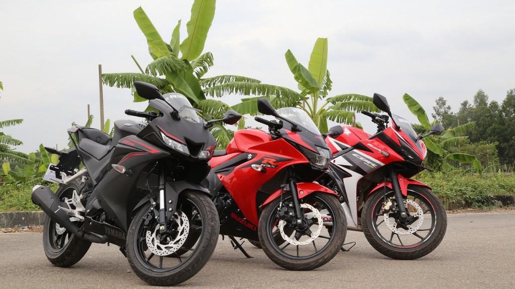three sports bikes parked in a row