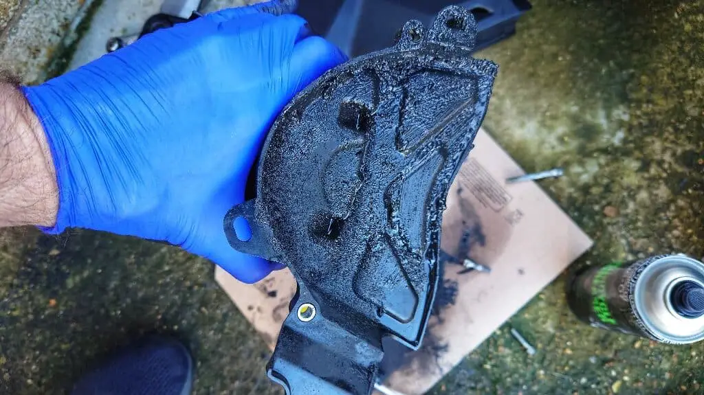 Excess chain lube and grease on fornt motorcycle sprocket cover