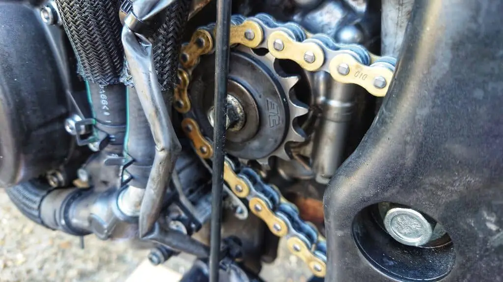 New motorcycle drive chain threaded through the new front sprocket