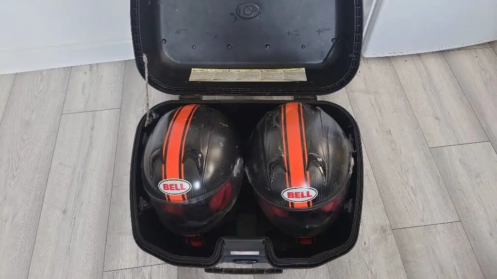 Two full face motorcycle helmets in Givi Trekker Top Box